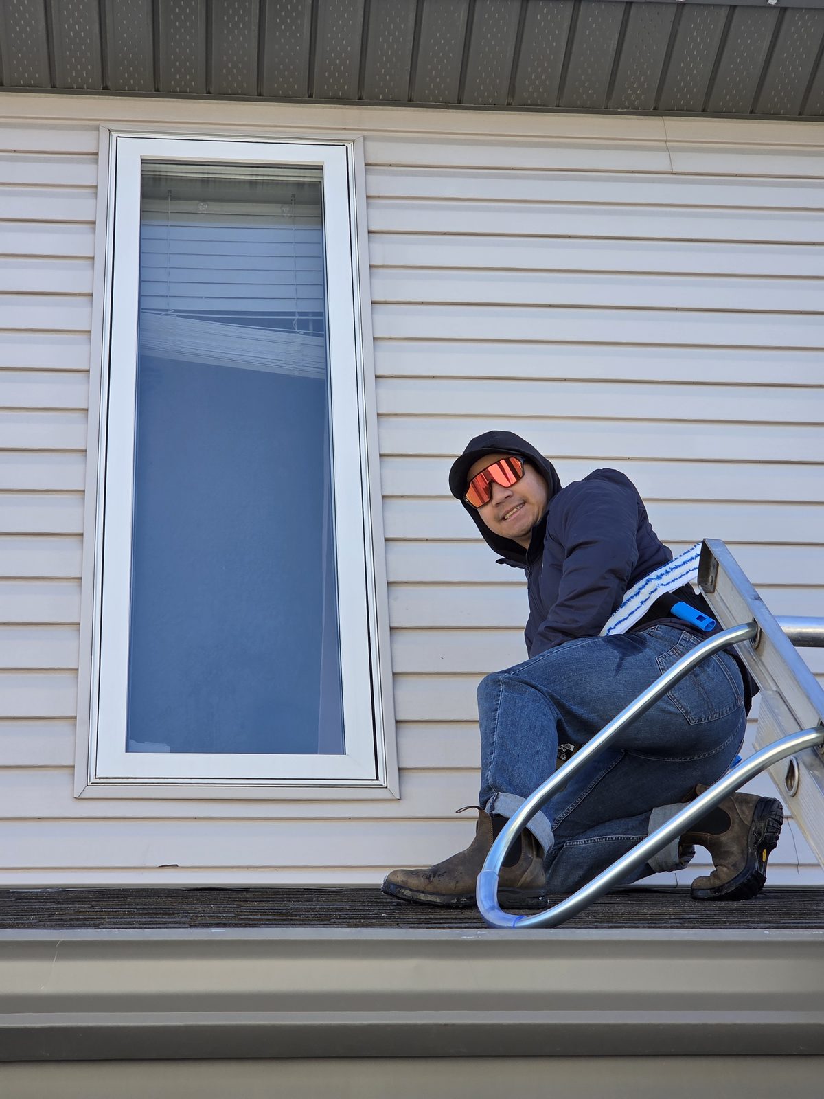 Joseph working a second-storey window from the ledge