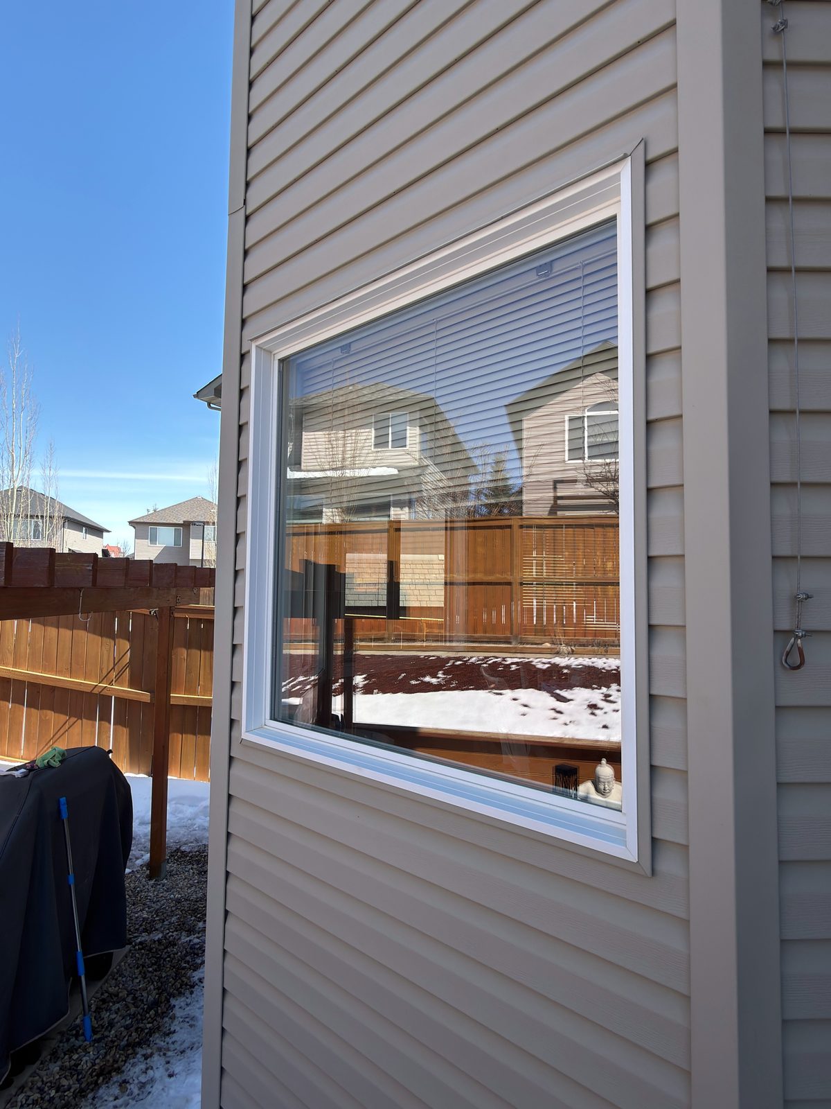 Corner of a two-storey home with spotless upper and lower windows