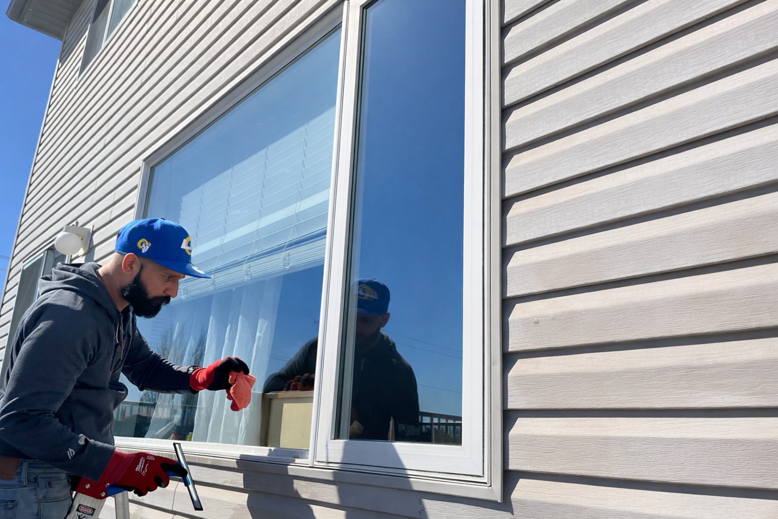 Darryl hand-squeegeeing a window to a streak-free finish